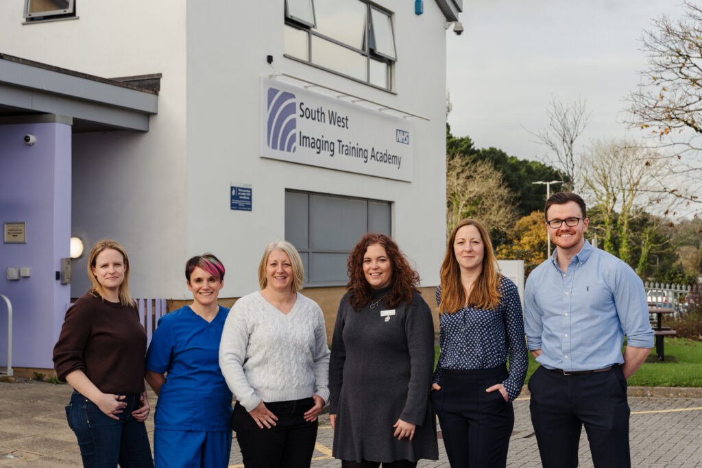 A group of people stood in front of a building